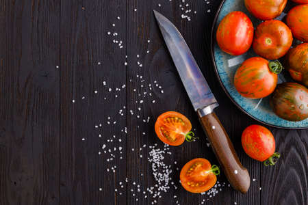 Red, ripe tomatoes on a dark background. Harvesting tomatoes. Top view. Copy spaceの写真素材