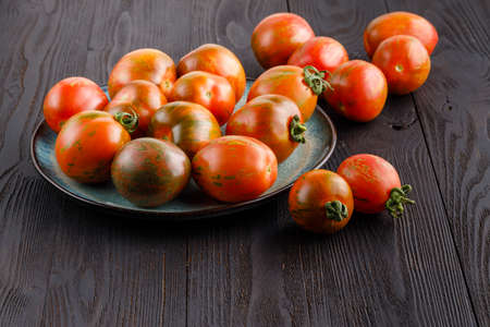 red tomatoes with dill on a wooden board. Home cookingの写真素材