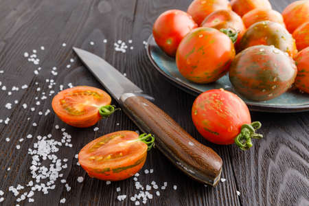 red tomatoes with dill on a wooden board. Home cookingの写真素材