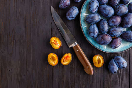 harvest fresh ripe plum in a saucepan on the table. cooking organic dessertの写真素材