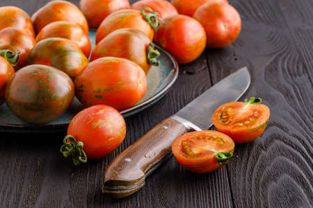 Fresh tomatoes and sauce on a rustic wooden backgroundの写真素材