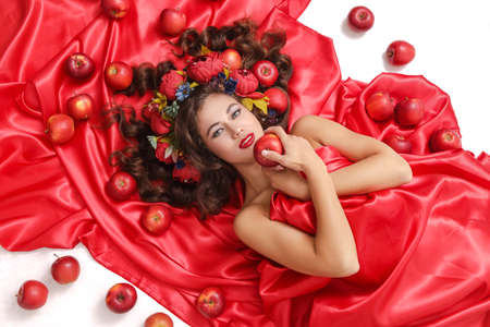 Spring Woman. Beauty Summer model girl with colorful flowers wreath and colorful hair.の写真素材