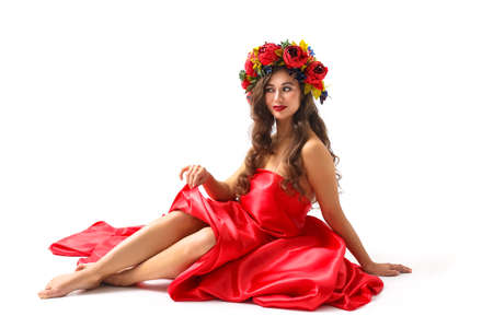 Beautiful Model Woman with Perfect Makeup, Long Curly Hair and Wreath of Flowersの写真素材