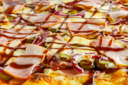 Pizza background. Pizza with sausage and other ingredients close up close up.の写真素材