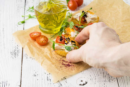 Bruschetta with cheese, cherry tomatoes and herbsの写真素材