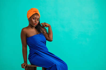 beautiful girl with African roots on a blue backgroundの写真素材