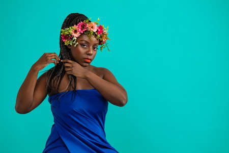 African woman with bright make up  with flowers on headの写真素材