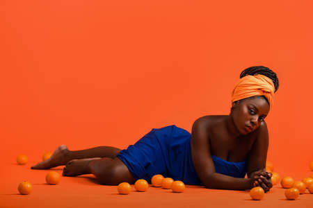 Young African model with a beautiful makeup in studio in vivid backgroundの写真素材