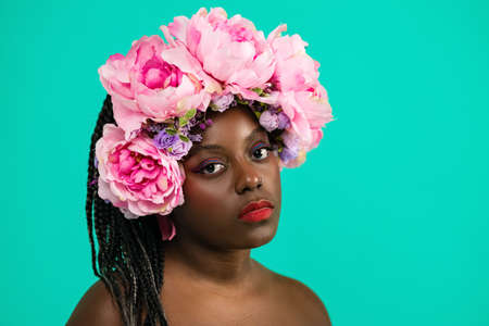 beautiful girl with African roots on a blue backgroundの写真素材