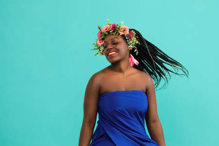 Excitement African American Fashion Model profile portrait . Satisfied Brunette young woman with afro hair style,creative make up, lips and eyeshadows on colorful backgroundの写真素材