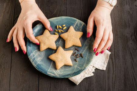 gingersnap in the form of asterisks on napkin on a wooden backgroundの写真素材