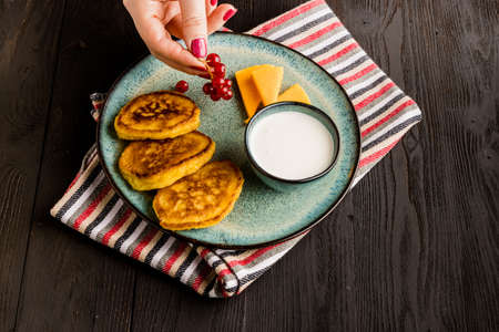 Cottage cheese pancakes, syrniki, curd fritters with fresh berryの写真素材