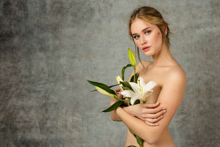 Girl and plant. Posing in a photo studioの写真素材