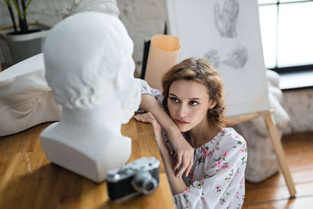 young girl posing in an art studio sitting