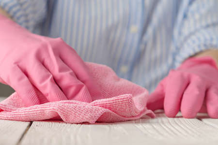 Surface disinfecting home cleaning with sanitizing antibacterial wipes protection against COVID-19 spreading wearing medical gloves. Sanitize surfaces prevention in hospitals and public spacesの写真素材