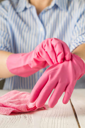 girl puts on protective gloves during the coronavirus epidemic. the use of protective gloves in an epidemic. covid-19 coronavirus protectionの写真素材