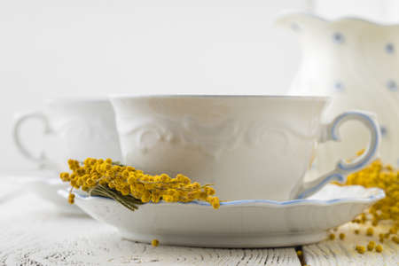 Elegant white porcelain tea set with cups and saucers. Luxury design with porcelain roses.の写真素材