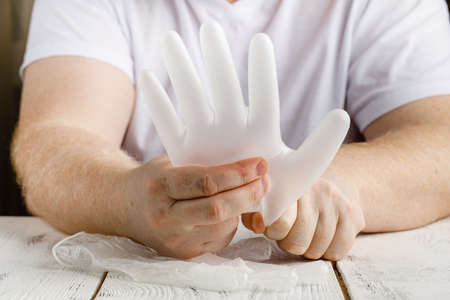 Man holding protective gloves