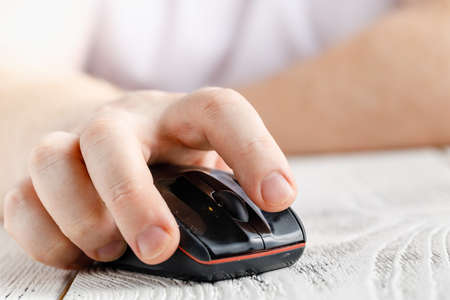 Closeup view of hand holding wireless mouseの写真素材