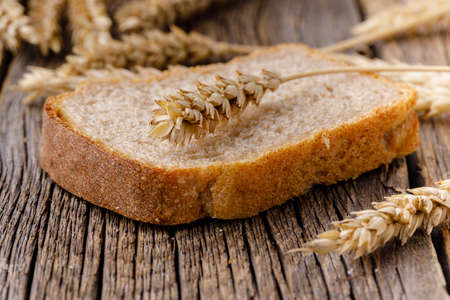 one piece of bread on wooden tableの写真素材