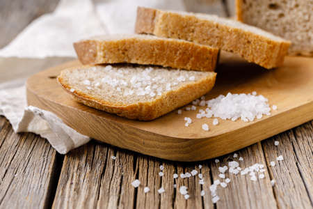 Sliced rye bread on cutting board closeupの写真素材