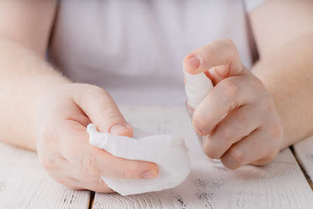 hands using bottle of hand sanitizer, hand desinfectant. preventing virus infection during epidemic...