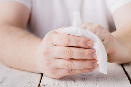 hands using bottle of hand sanitizer, hand desinfectant. preventing virus infection during epidemic or pandemicの写真素材