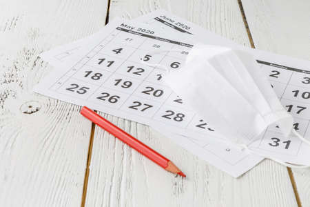 Simple desk calendar for 2020 with self protection face mask. coronavirus concept. Deadline concept with sheet of monthly calendar. Coronavirus COVID-19. の写真素材