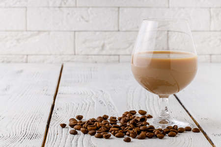 coffee beans from the white ceramic cup