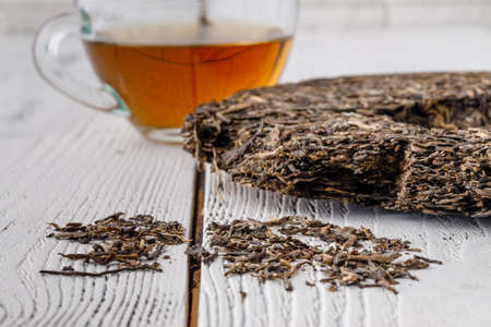 Leaves of puer tea in wooden tabnleの写真素材