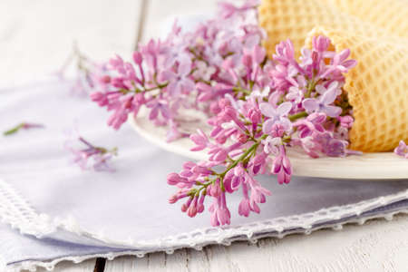 Romantic gift lilac flowers on tableの写真素材