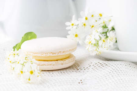 White french macaroon close up on table with flowersの写真素材