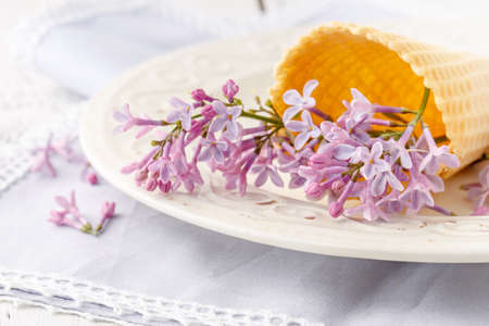 Romantic gift lilac flowers on tableの写真素材