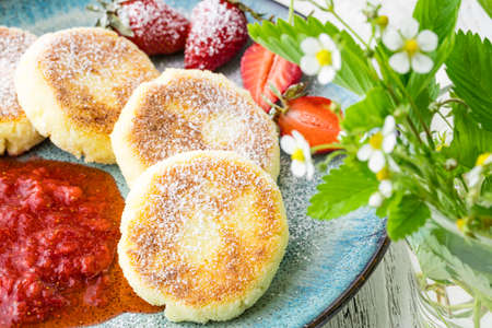 Cottage cheese pancakes, syrniki, curd fritters with berriesの写真素材