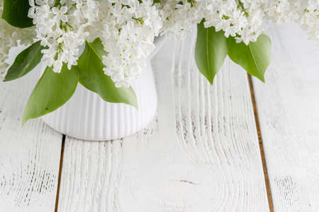 White lilac flowers on wooden tableの写真素材