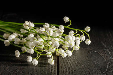 Lily of the valley on dark wooden tableの写真素材