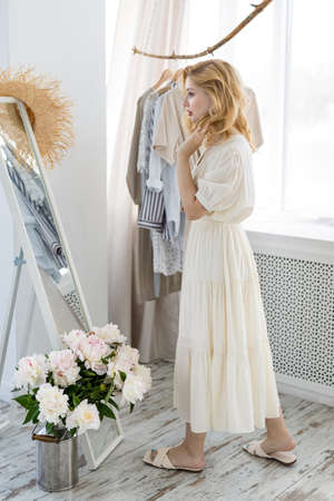 Happy woman trying on new dress in showroom. Fashion conceptの写真素材