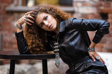 Beautiful modern girl near the brickwall. Youth style. Fashion shot.の写真素材
