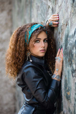 Beautiful modern girl near the brickwall. Youth style. Fashion shot.の写真素材