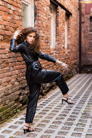 Beautiful modern girl near the brickwall. Youth style. Fashion shot.の写真素材