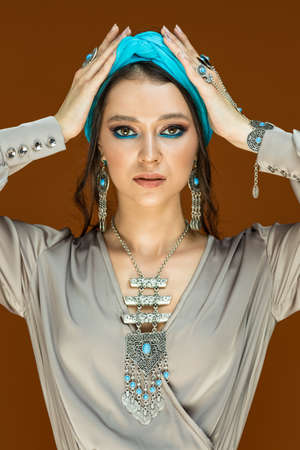 Glamor model fashion girl with earrings and silk dressの写真素材