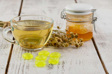 Cup of delicious camomile tea on tableの写真素材