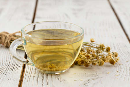 Portion of dried Camomile on an old wooden tableの写真素材