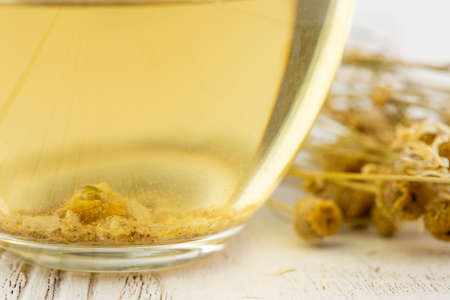 Cup of delicious camomile tea on tableの写真素材