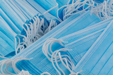 Many stacked medical blue masksの写真素材