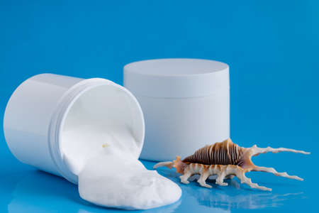 Protective sunscreen or sunblock cream and sunbath sun care lotion in white plastic bottlesの写真素材