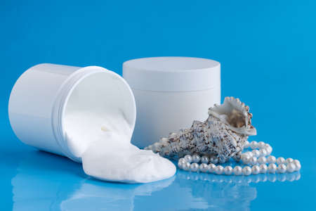 Protective sunscreen or sunblock cream and sunbath sun care lotion in white plastic bottlesの写真素材