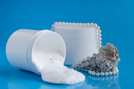 Protective sunscreen or sunblock cream and sunbath sun care lotion in white plastic bottlesの写真素材
