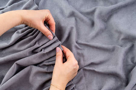 Close up of woman hands hanging curtainの写真素材