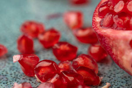 ripe pomegranate on a table on a blue backgroundの写真素材